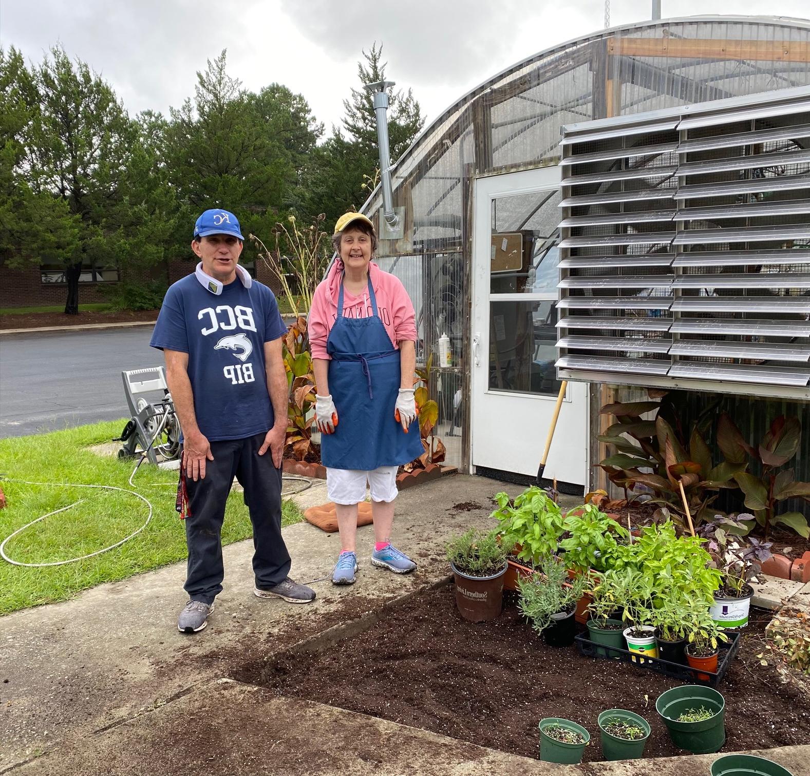 Students working in Brunswick Blooms greenhouse